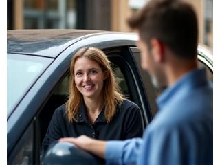 Smiling rideshare driver helping a passenger into a clean car in an Australian city